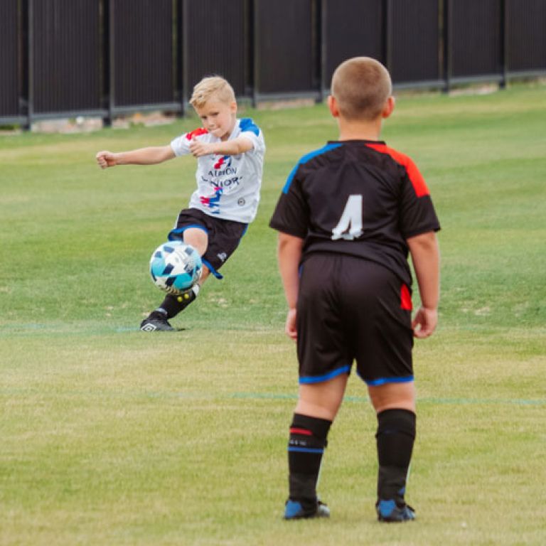 2 boys playing football